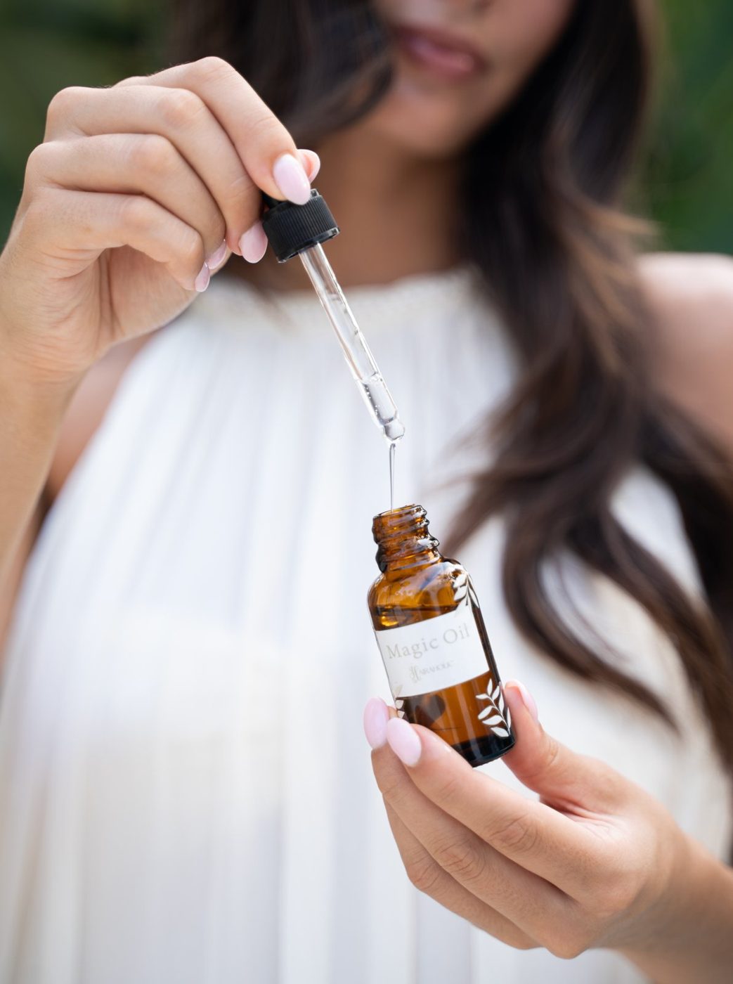 A dropper of hair oil, measured out